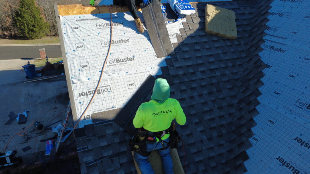 Roof repair in progress by Natural Construction Group NWA